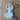 Handmade ceramic dog ornament displayed on a wooden background.