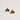 A pair of gold-tone stud earrings shaped like dachshund dog heads wearing red Santa hats with clear rhinestone trim, shown on a light off-white background.