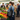 Woman shopping at an outdoor farmers market with a tote bag.