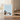 Greeting card with illustrations of dogs and the word 'hello' on a wooden surface.