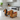 Two ceramic salt and pepper shakers shaped like dachshunds dressed as hot dogs, shown on a plain white background.