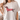 Person wearing a white t-shirt with a dachshund graphic and red heart pattern.
