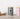 Two striped pet treat jars with paw prints on a wooden surface next to a colorful rope toy.