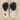 Pair of slippers with cartoon dog pattern and fluffy dark blue tops on a white background