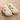 Pair of slippers with colorful dog pattern on a beige background