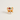 A small enamel pin shaped like a fox face wearing a red glittery Santa hat with green holly leaves and a white pearl accent, shown on a plain light background.