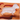 A translucent frosted glass or acrylic lamb-shaped object resting on an orange silicone mold or tray against a white background.